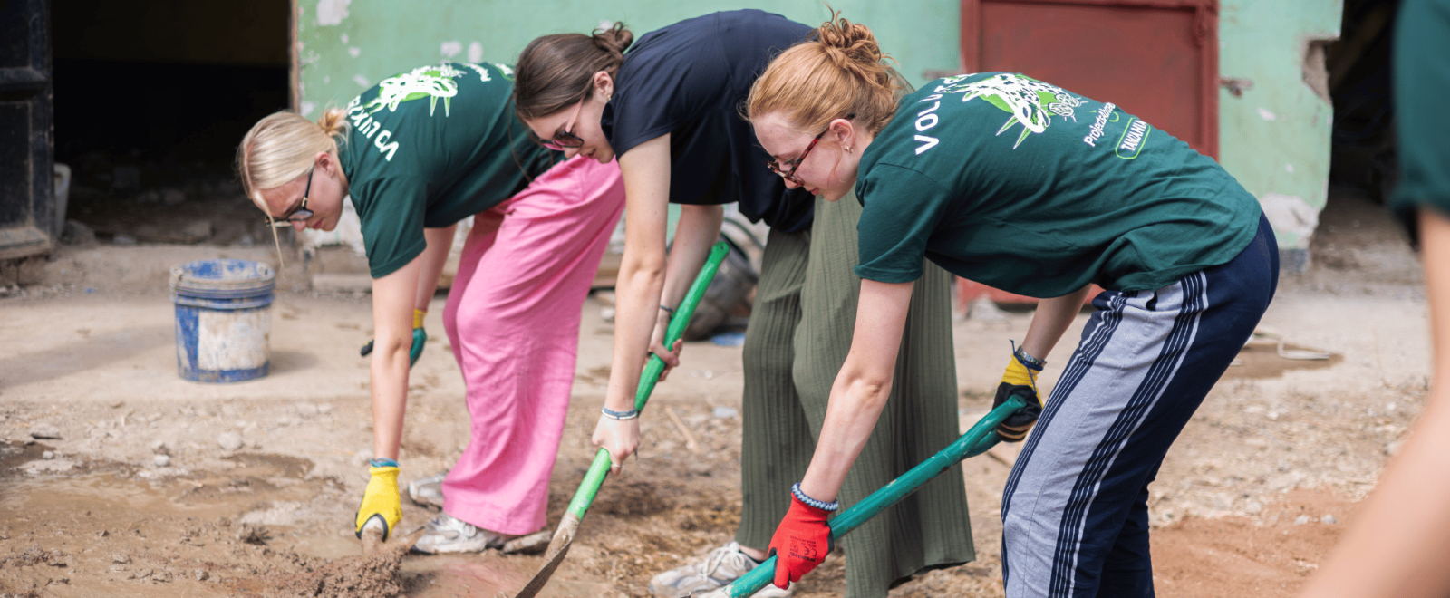 Teen participants help to dig out an area in Tanzania